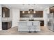 The kitchen features granite countertops, stainless steel appliances, a center island, and dark wood cabinetry at 2238 Thelen Ave, North Las Vegas, NV 89086