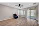 Cozy living room with wood-look floors, natural light, and a sliding glass door at 2238 Thelen Ave, North Las Vegas, NV 89086
