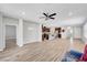 Spacious open-plan living area with modern kitchen, stylish lighting, and sleek wood-look tile flooring at 2238 Thelen Ave, North Las Vegas, NV 89086