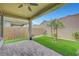 Relaxing covered patio with pavers, overlooking the backyard's artificial turf and privacy wall at 2238 Thelen Ave, North Las Vegas, NV 89086