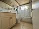 Bathroom featuring a decorative glass shower door, ample counter space, and tile flooring at 2300 Pardee Pl, Las Vegas, NV 89104