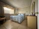 Comfortable bedroom with a well-lit window and vintage decor at 2300 Pardee Pl, Las Vegas, NV 89104