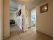 Hallway featuring tile flooring, access to bathroom, and unique shelving at 2300 Pardee Pl, Las Vegas, NV 89104
