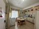 Practical kitchen featuring a dining area, classic appliances, and window with decorative curtains at 2300 Pardee Pl, Las Vegas, NV 89104