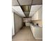 Galley kitchen showcasing abundant white cabinetry, older appliances, and tiled flooring at 2300 Pardee Pl, Las Vegas, NV 89104