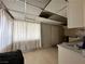 View of the kitchen area with paneled walls, tiled flooring, and a drop ceiling at 2300 Pardee Pl, Las Vegas, NV 89104