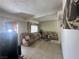 A living room featuring tile floors, comfortable seating, and large decorative artwork at 2300 Pardee Pl, Las Vegas, NV 89104