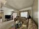 Living room showcasing tile floors, plush sofas, a see-through coffee table, and neutral wall decor at 2300 Pardee Pl, Las Vegas, NV 89104