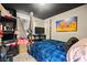 Bedroom with a dark ceiling featuring a four-poster bed with blue covers and organized storage at 251 Las Palmaritas Dr, Las Vegas, NV 89110