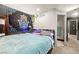 Cozy bedroom with a vibrant tapestry and access to an en-suite bathroom at 251 Las Palmaritas Dr, Las Vegas, NV 89110