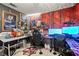 Custom bedroom featuring a vibrant red mural and equipped as an arcade and office at 251 Las Palmaritas Dr, Las Vegas, NV 89110