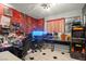Custom bedroom featuring a vibrant red mural and equipped as an arcade and office at 251 Las Palmaritas Dr, Las Vegas, NV 89110