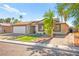 Charming single-story home featuring a two-car garage, desert landscaping, and a welcoming facade at 251 Las Palmaritas Dr, Las Vegas, NV 89110