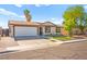 Charming single-story home featuring a two-car garage, desert landscaping, and a welcoming facade at 251 Las Palmaritas Dr, Las Vegas, NV 89110