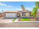 Charming single-story home featuring a well-maintained front yard, a two-car garage, and mature trees at 251 Las Palmaritas Dr, Las Vegas, NV 89110
