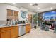 Open kitchen with wooden cabinetry, stainless steel appliances, and a view of the backyard at 251 Las Palmaritas Dr, Las Vegas, NV 89110