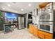 Updated kitchen with stainless steel appliances, modern cabinetry, and tile flooring at 251 Las Palmaritas Dr, Las Vegas, NV 89110