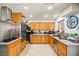 Well-lit kitchen with wooden cabinets, modern appliances, and sleek countertops at 251 Las Palmaritas Dr, Las Vegas, NV 89110