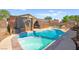 Backyard pool with a jacuzzi and a covered outdoor kitchen area, perfect for entertaining and relaxing at 251 Las Palmaritas Dr, Las Vegas, NV 89110
