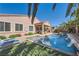 Backyard oasis featuring a pool, spa, covered patio, and lush landscaping at 280 Goldstar St, Henderson, NV 89012