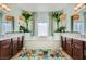 Bathroom with double vanities, soaking tub, and decorative plants at 280 Goldstar St, Henderson, NV 89012