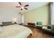 Large bedroom with wood floors, ceiling fan, and comfortable seating area at 280 Goldstar St, Henderson, NV 89012