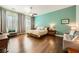 Relaxing bedroom boasts wood floors, large window, and soft colors at 280 Goldstar St, Henderson, NV 89012