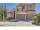 Two-story house with desert landscaping featuring a two car garage and a well maintained lawn at 280 Goldstar St, Henderson, NV 89012