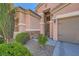 Close up of the front door and landscaping of a two story house with a two car garage at 280 Goldstar St, Henderson, NV 89012