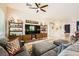 Comfortable living room with tile flooring, a ceiling fan, and a decorative media center at 280 Goldstar St, Henderson, NV 89012