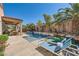 Backyard pool with waterfall feature, patio, and lounge chairs at 280 Goldstar St, Henderson, NV 89012