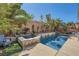 Backyard pool and jacuzzi surrounded by palm trees and lush landscaping at 280 Goldstar St, Henderson, NV 89012