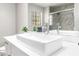Bathroom with white vessel sink and vanity, large mirror, with view of shower with marble tile at 2851 S Valley View Blvd # 1044, Las Vegas, NV 89102