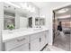 Bathroom with a white vanity, rectangular sink, and a large mirror, with a view into the bedroom at 2851 S Valley View Blvd # 1044, Las Vegas, NV 89102