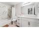 Modern bathroom features a shower over tub with marble tile and a sleek white vanity with rectangular sink at 2851 S Valley View Blvd # 1044, Las Vegas, NV 89102