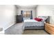 Cozy bedroom with neutral carpet, a comfortable bed, and a window with drapes at 2851 S Valley View Blvd # 1044, Las Vegas, NV 89102