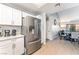 Stainless steel refrigerator in an updated kitchen with wood-look flooring, open to the dining area at 2851 S Valley View Blvd # 1044, Las Vegas, NV 89102