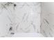 Close-up of tub shower tiled with marble-look porcelain tiles at 2851 S Valley View Blvd # 1044, Las Vegas, NV 89102