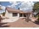 Spacious backyard with desert landscaping, a concrete patio, and a tiled roof home at 3522 Shonna Way, North Las Vegas, NV 89032