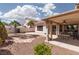 Large backyard with desert landscaping, a covered patio, and a view of the home's exterior at 3522 Shonna Way, North Las Vegas, NV 89032