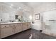 Bathroom featuring dual sinks, a soaking tub, and a glass-enclosed shower at 3522 Shonna Way, North Las Vegas, NV 89032
