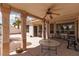 Relax on the covered patio with stone pillars and a ceiling fan, perfect for outdoor dining and lounging at 3522 Shonna Way, North Las Vegas, NV 89032