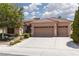Inviting home features a two-car garage, a tiled roof, and low-maintenance landscaping at 3522 Shonna Way, North Las Vegas, NV 89032