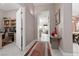 Open hallway with tile floors leading to multiple rooms and an open doorway, creating an inviting flow throughout the home at 3522 Shonna Way, North Las Vegas, NV 89032