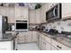 A functional kitchen featuring granite counters, stainless steel appliances and ample cabinet space for storage and meal preparation at 3522 Shonna Way, North Las Vegas, NV 89032