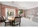 Open-concept living area features a dining table, a sofa, and large windows for natural light at 3522 Shonna Way, North Las Vegas, NV 89032
