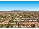 Expansive view of a residential community featuring neatly arranged homes, solar panels, and mountain views at 358 Whispering Tree Ave, Las Vegas, NV 89183