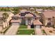 Expansive home with a solar panel system, well-maintained lawn, and neatly arranged landscaping at 358 Whispering Tree Ave, Las Vegas, NV 89183