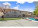 View of the home's backyard with pool, patio, turf, and outdoor seating area at 358 Whispering Tree Ave, Las Vegas, NV 89183