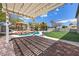 Lush backyard featuring a pool, gazebo, and manicured landscaping, perfect for entertaining at 358 Whispering Tree Ave, Las Vegas, NV 89183